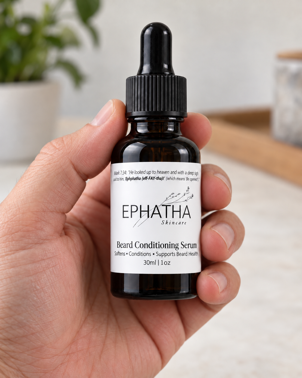 Ephatha Beard Conditioning Serum 1 oz bottle shown in hand for scale